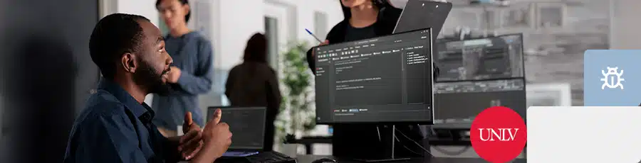 Sitting next to his computer and holding a thumb up after he was Preparing for the CEH Exam in Las Vegas