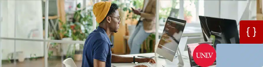 Looking at his computer screen and learning about the AWS Certification Mosaic